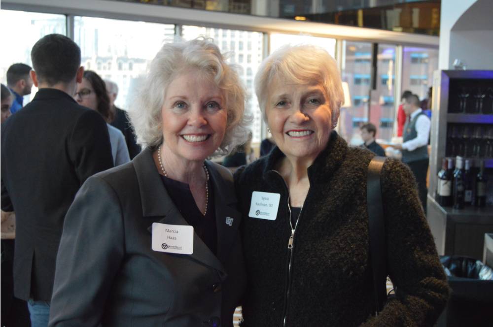 Marcia Haas smile for a photo together with an alumna
